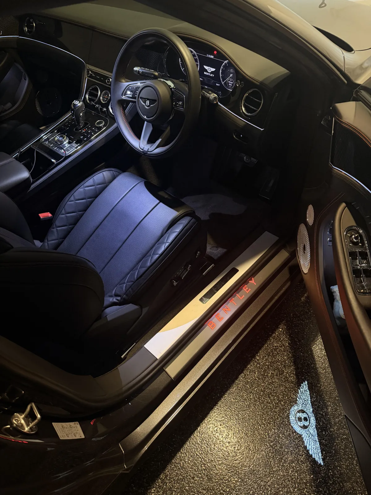 Two cars parked in a parking garage next to each other