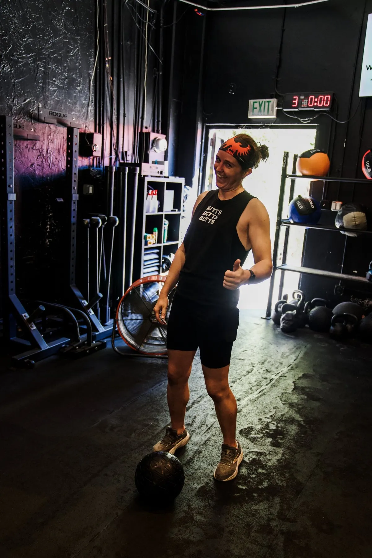 A member giving a thumbs up mid-workout