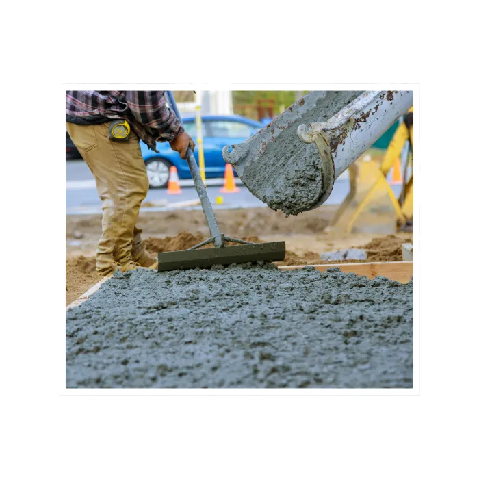 Construction worker pouring fresh concrete for a residential project, showcasing volumetric ready-mix services.