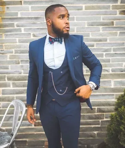 a man in a suit and red tie