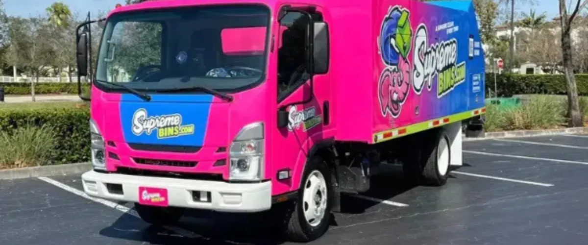 Supreme Bins cleaning service truck parked in a lot, ready for trash bin cleaning services.