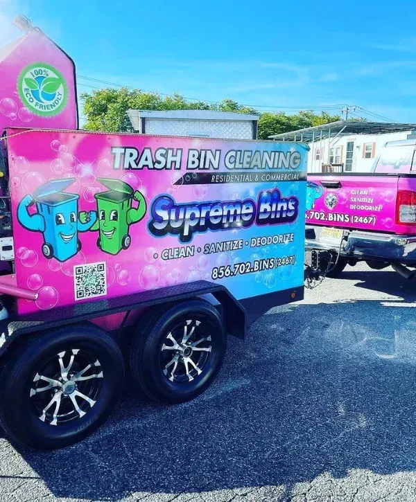 Supreme Bins trash bin cleaning trailer with eco-friendly branding used for mobile bin washing and deodorizing.
