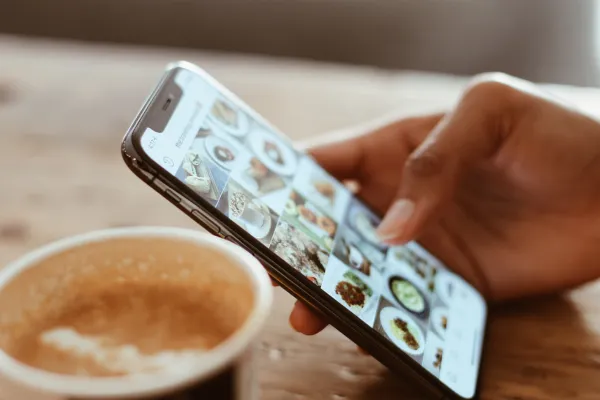 close up of woman on phone scrolling on instagram