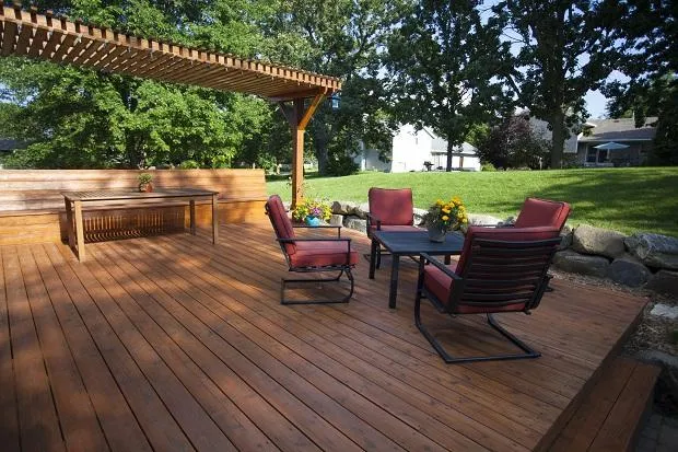 Custom wood backyard deck with seating and pergola built by A & A Fence Installation in San Antonio
