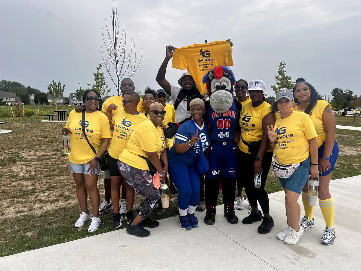 Gakobe Strong supporters with Detroit Pistons mascot Hooper at the Detroit 5K Walk