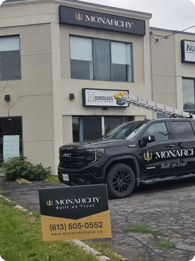Monarchy Roofing Ottawa's truck and storefront in Ottawa, ON, showing trusted Roofing Contractor signage and ladder setup