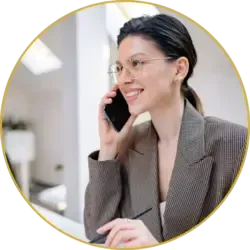 Smiling customer support representative in glasses talking on the phone about roofing concerns and inquiries