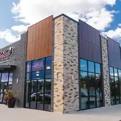 Retail building with commercial roofing system and storefront exterior in business area