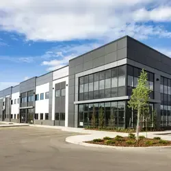 Large industrial building with commercial roofing system and modern warehouse exterior