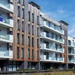 Modern condominium building with multi-unit residential roofing system