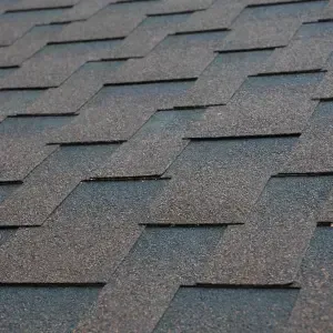 A close-up view of a Three-Tab Asphalt Shingles roofing systtem, showing the overlapping pattern and textured surface.