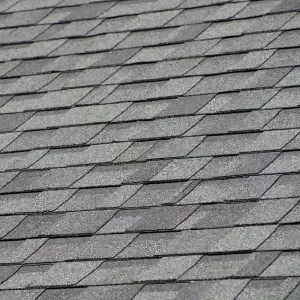 A close-up view of a Architectural Asphalt Shingles roofing system, showing the repeating pattern of the shingles.