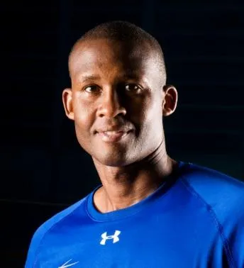 Coach Charlie Miller dribbling basketball