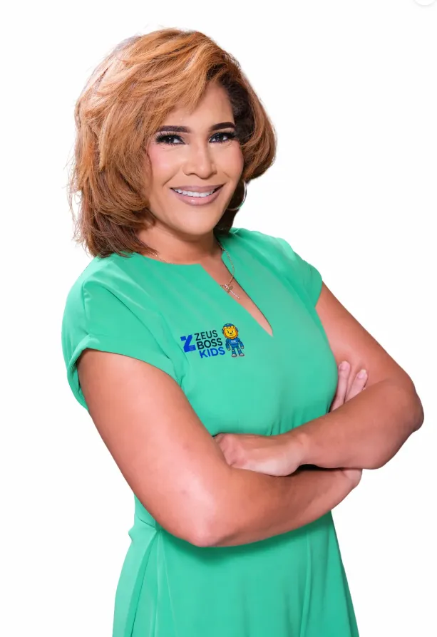 man in black t-shirt and brown hat sitting on rock