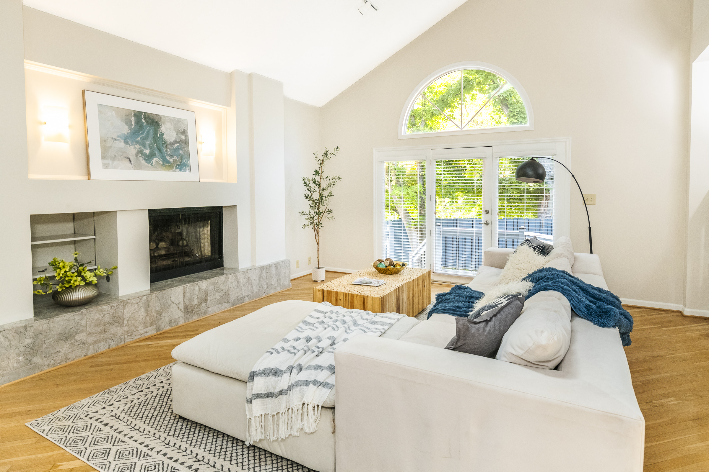 Bright living room with vaulted ceiling, fireplace, and hardwood floors in Bloomington Indiana home for sale — Lesa Miller Real Estate