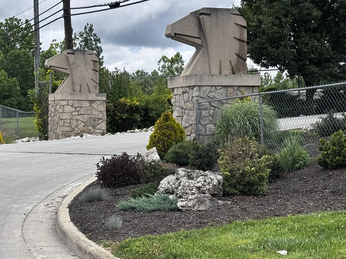 Carved limestone eagle-head sculptures atop the stone entrance pillars at Indiana Limestone in Bedford, Indiana
