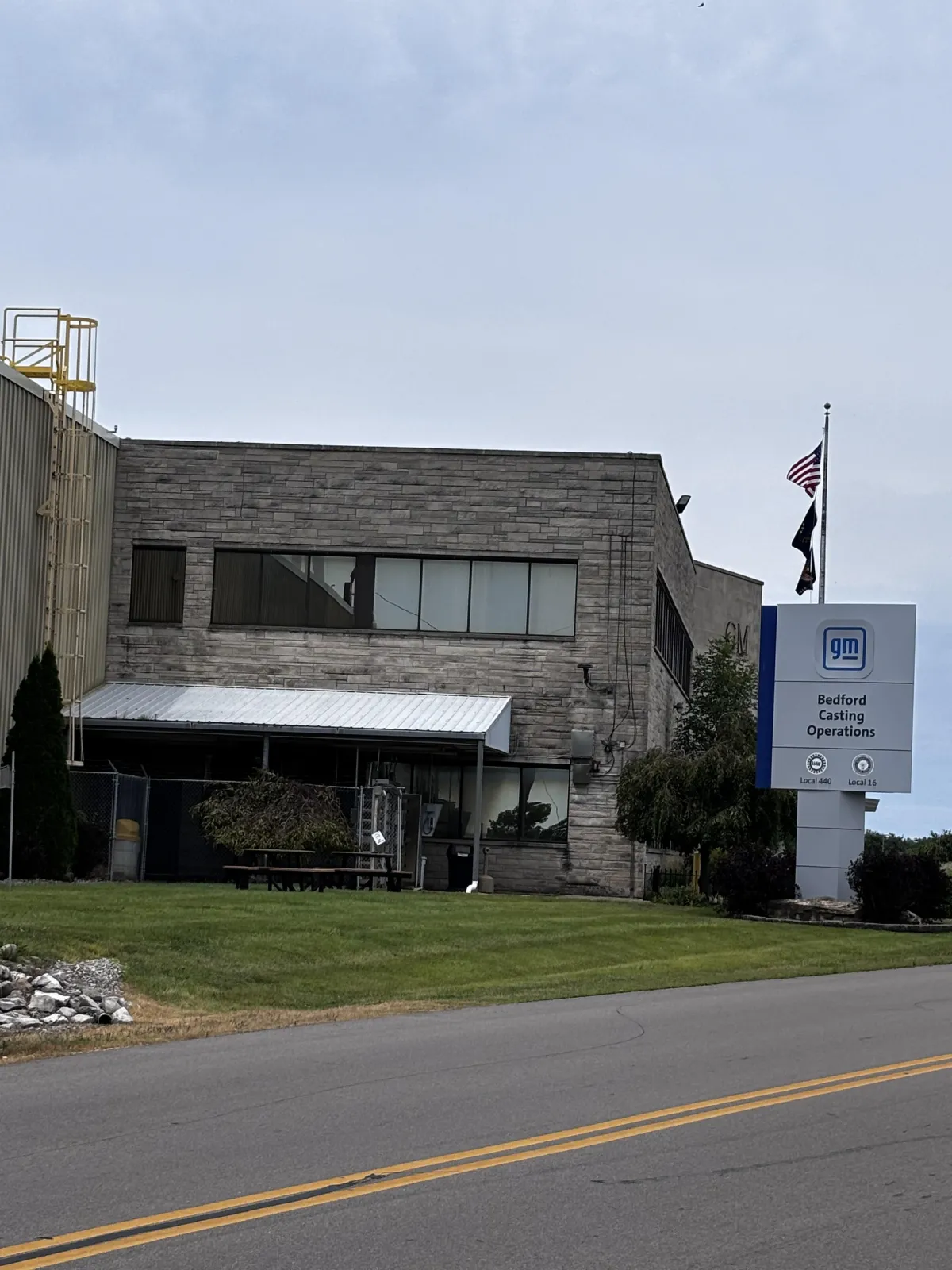 GM Bedford Casting Operations plant in Bedford Indiana, limestone office building with the gm entrance sign and UAW Local 440 and Local 16 markers