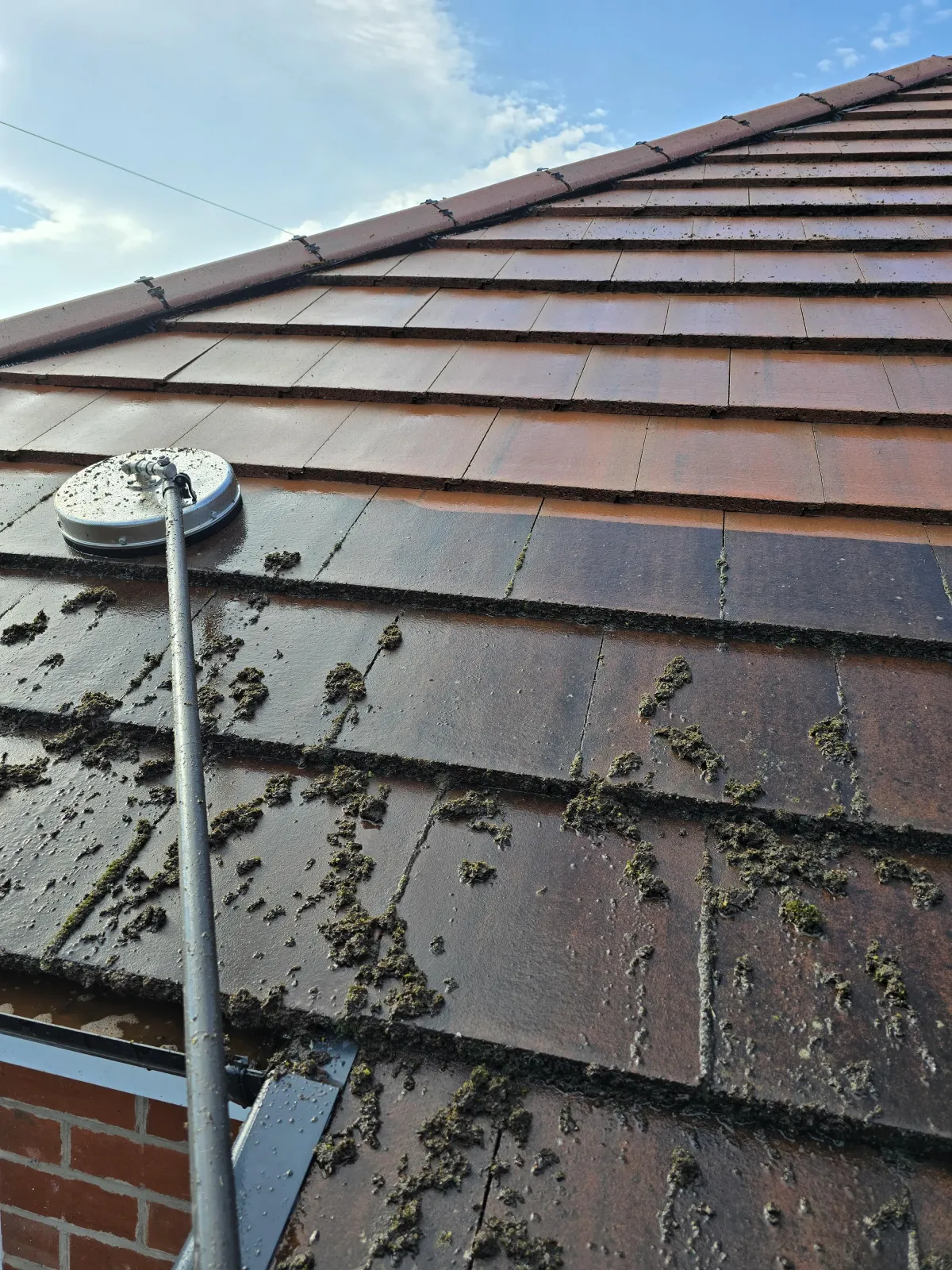 pressure washer being used for professional roof cleaning