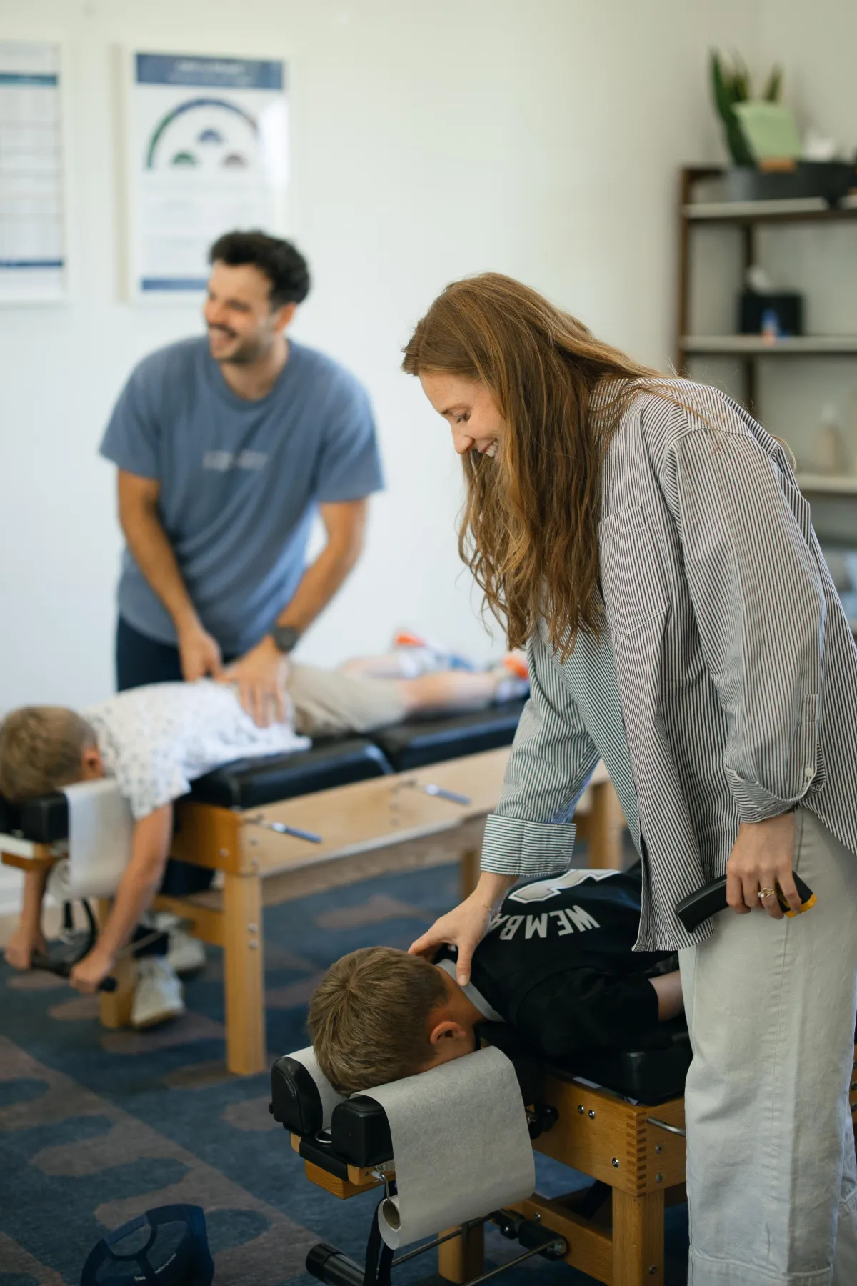 Pediatric chiropractor gently checking a baby in a calm clinic