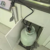 LPG gas bottle connected to an outdoor BBQ