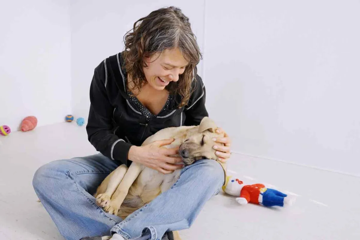 Woman holding puppy in her lap