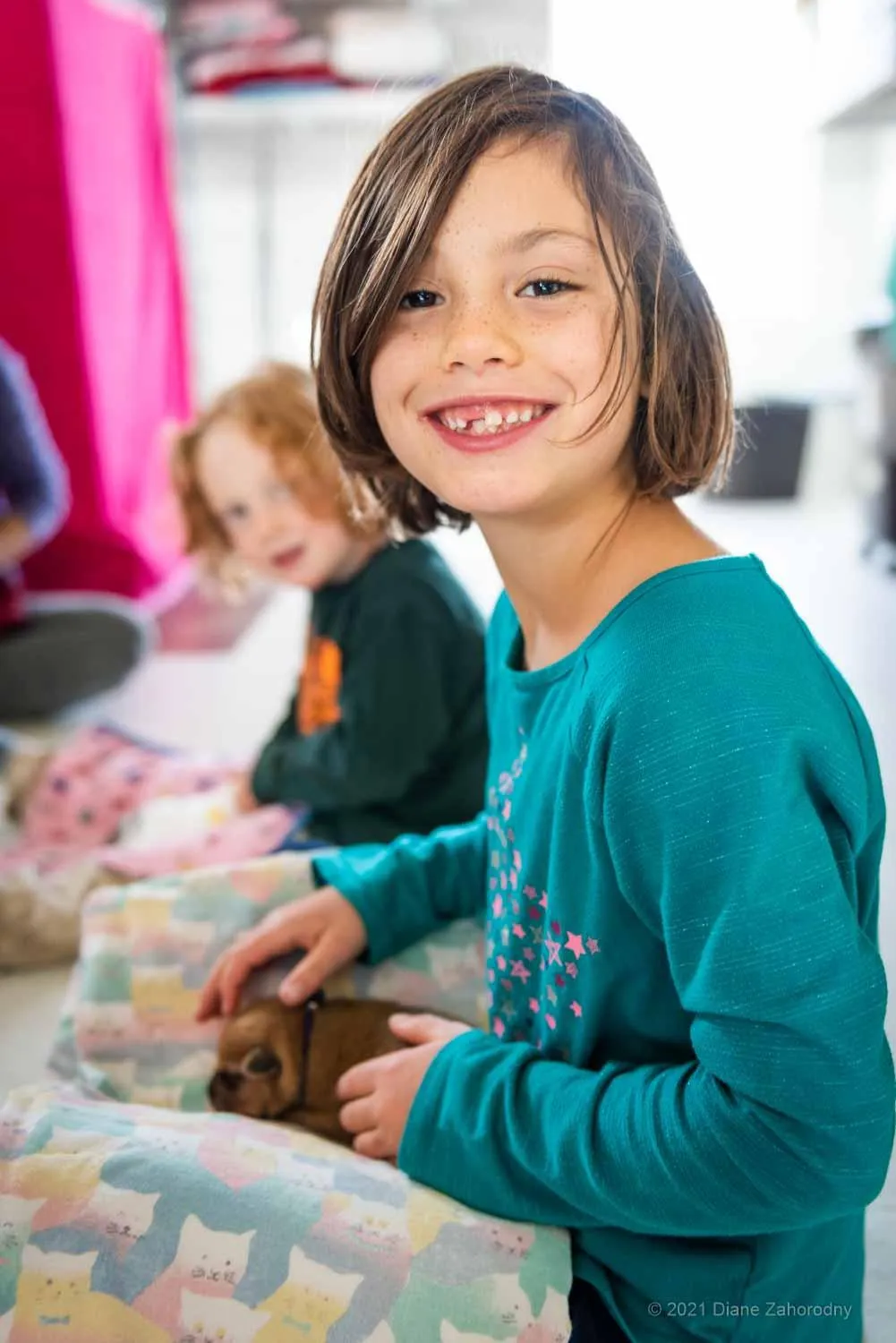 Smiling girl holding puppy