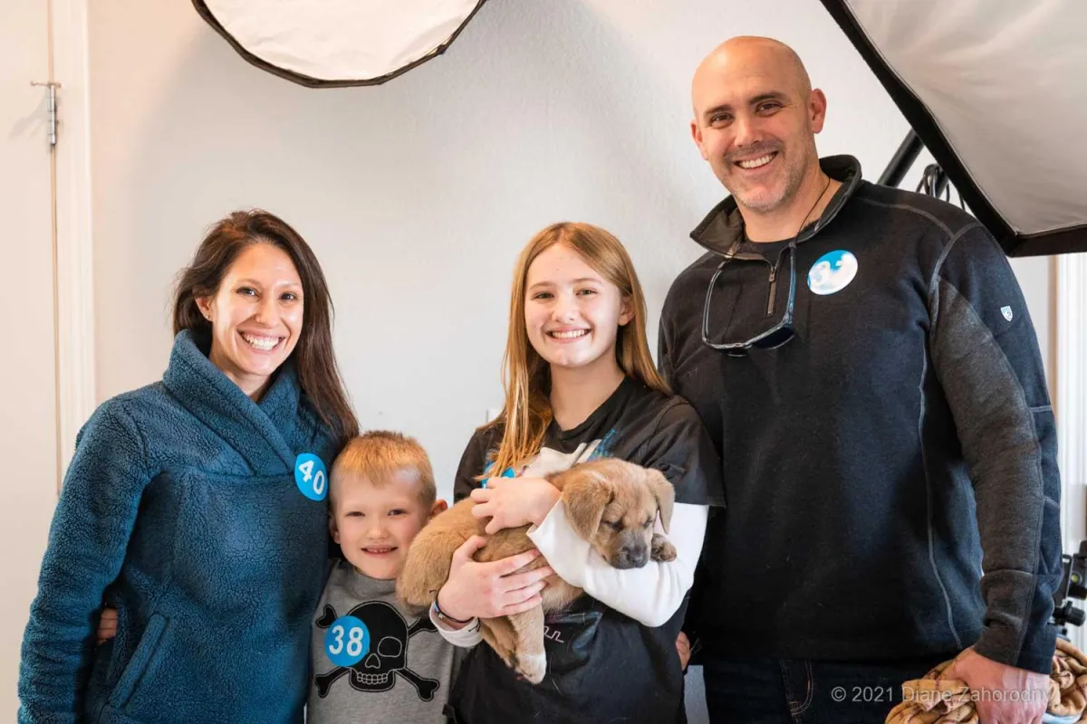 Family of four with their new puppy