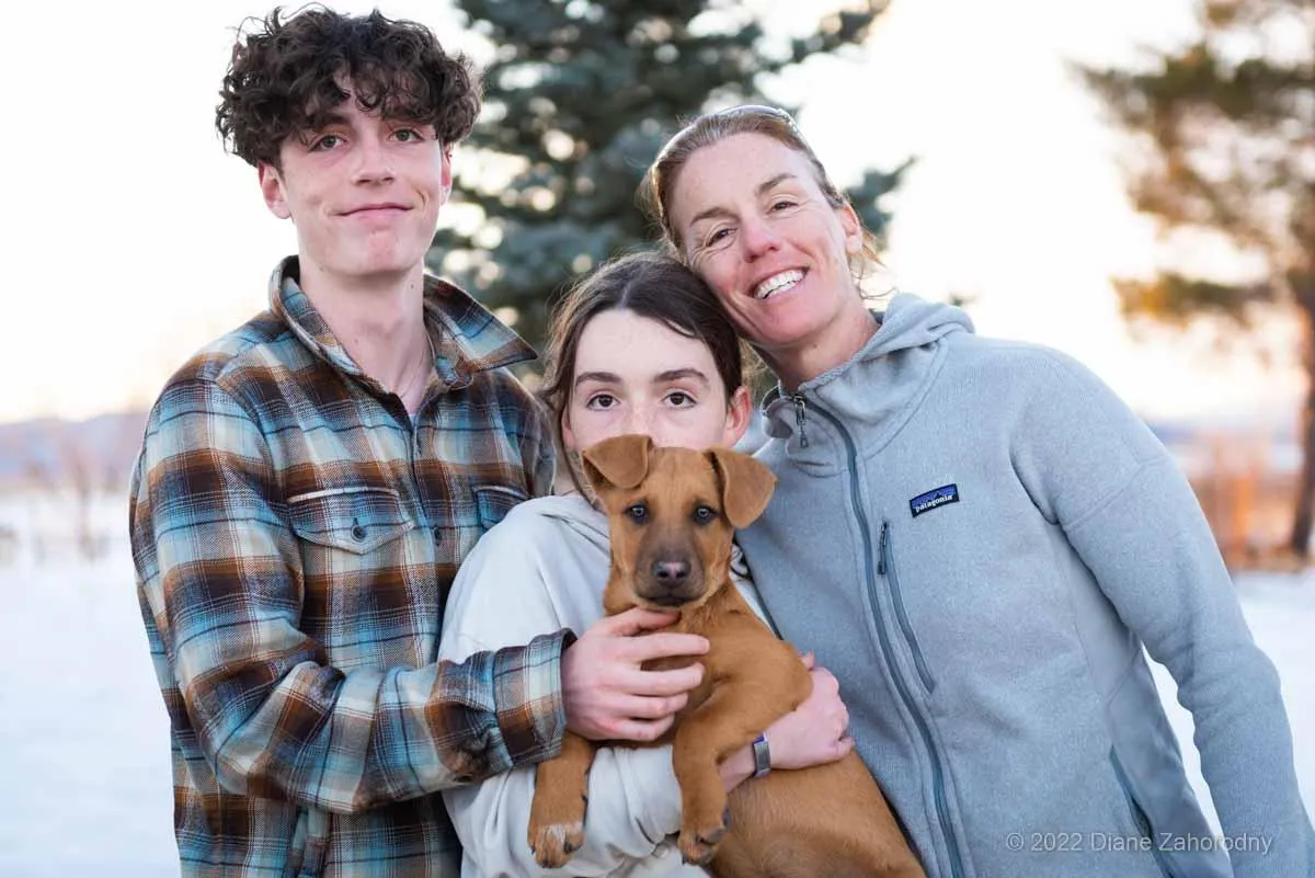 Small family holding their new puppy