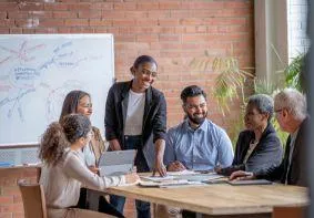 M&A professionals networking in relaxed setting, cementing new relationships and continuing merger strategy conversations for meaningful collaboration