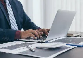 Business professional accessing lifetime M&A resources on laptop, demonstrating permanent access to Boston Summit session recordings, slide decks, and editable integration tools for ongoing team collaboration