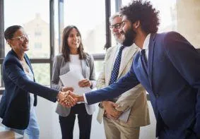 Diverse M&A professionals making meaningful connections through facilitated networking at Boston Summit, building relationships that drive successful merger outcomes