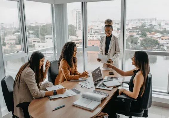 A communication team executing strategic planning session in modern conference room, implementing strong communication frameworks to prevent talent exodus during merger integration