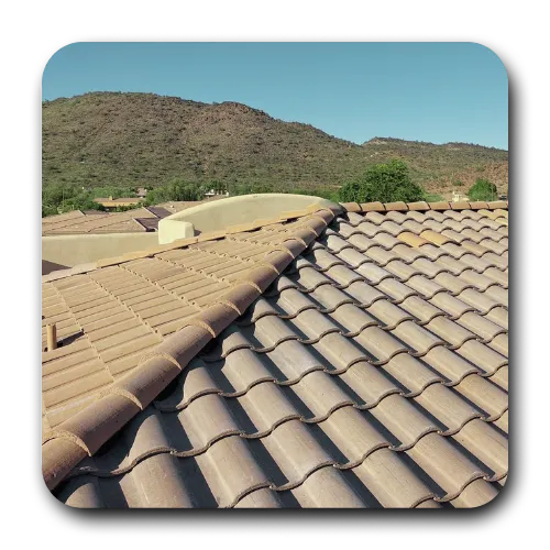 Arizona roofing contractors performing a roof inspection on a high-end Scottsdale home with curved clay tiles.