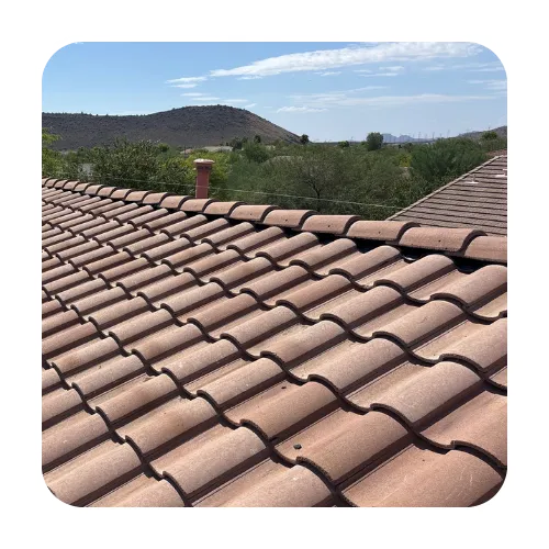 Arizona roofing contractors performing a roof inspection on a high-end Scottsdale home with curved clay tiles.