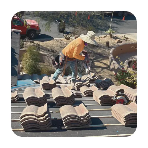 Expert local roofers installing new tile underlayment and stacking roof tiles for a full replacement in Scottsdale.