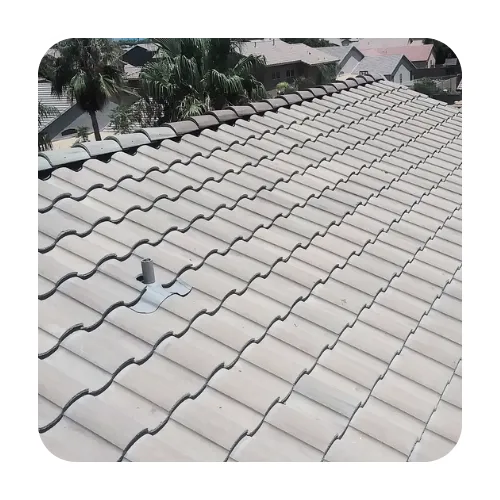 Professional tile roof repair in Scottsdale, AZ, featuring tan concrete S-tile roofing on a residential home.