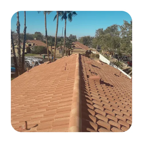 Arizona roofing contractors performing a roof inspection on a high-end Scottsdale home with curved clay tiles.