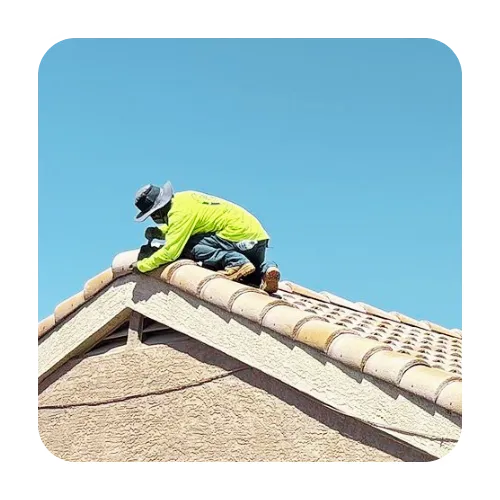 Expert roofer from Arizona's Finest Roofing repairing a tile roof peak to prevent monsoon season leaks in Apache Junction.