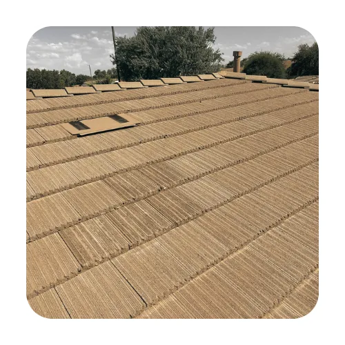 Professional roof inspection of flat concrete tiles on a Gilbert AZ home showing a solar attic fan and uniform tile rows.