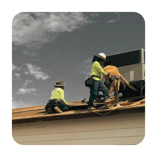 Professional Gilbert roofing crew performing a full roof replacement around a rooftop AC unit on a clear day.