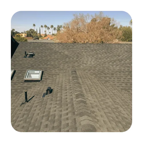New architectural shingle roof installation on a Gilbert home featuring a skylight and professional ridge venting.