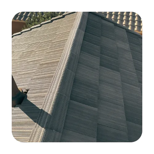 Close-up of charcoal gray flat tile roof with ridge cap tiles installed by a local Gilbert roofing contractor.