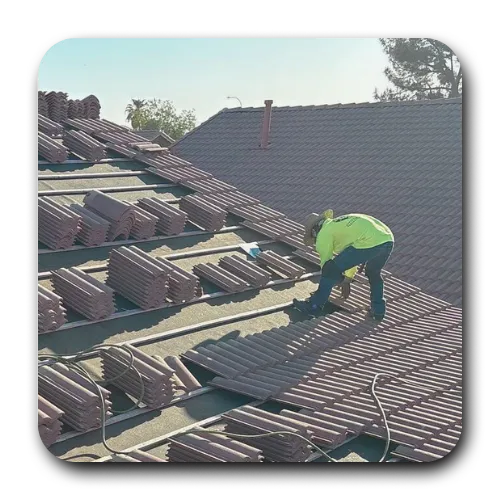 Chandler roofing contractor loading concrete roof tiles onto new batten strips during a full tile R&R (remove and replace).