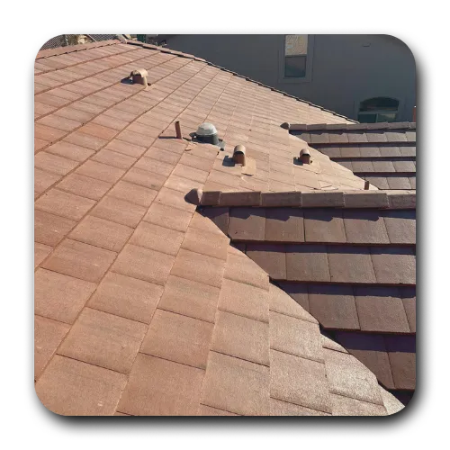 Detailed view of a desert tan flat tile roof in Chandler, AZ, featuring integrated solar tube lighting and attic ventilation.