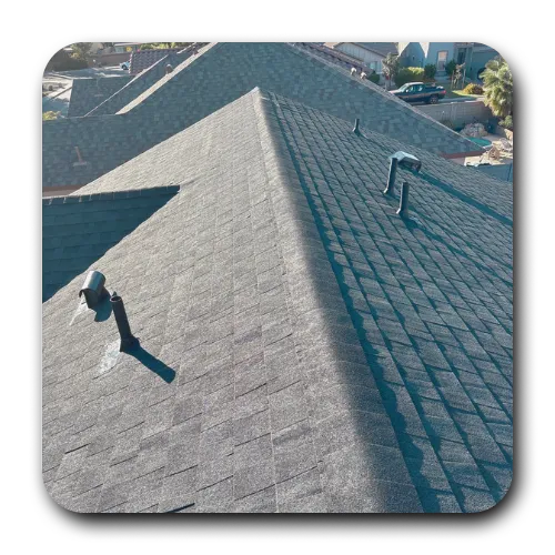 High-definition asphalt shingle roof in a Chandler residential neighborhood, featuring ridge vents and lead pipe jacks.