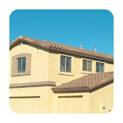 Two-story residential home in San Tan Valley featuring a tan concrete S-tile roof with professional ridge cap installation.