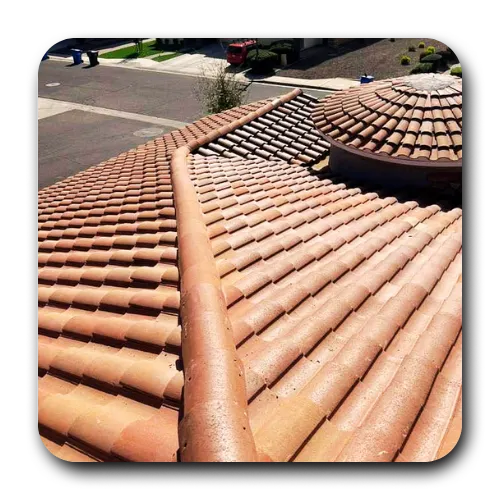 Detailed view of a clay tile valley and circular roof feature completed by a professional roofer phoenix.