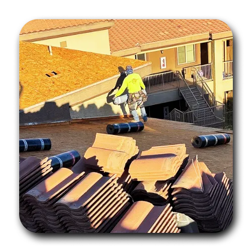 A professional roofer queen creek preparing a roof deck for new tile installation, showcasing safety gear and precision workmanship.