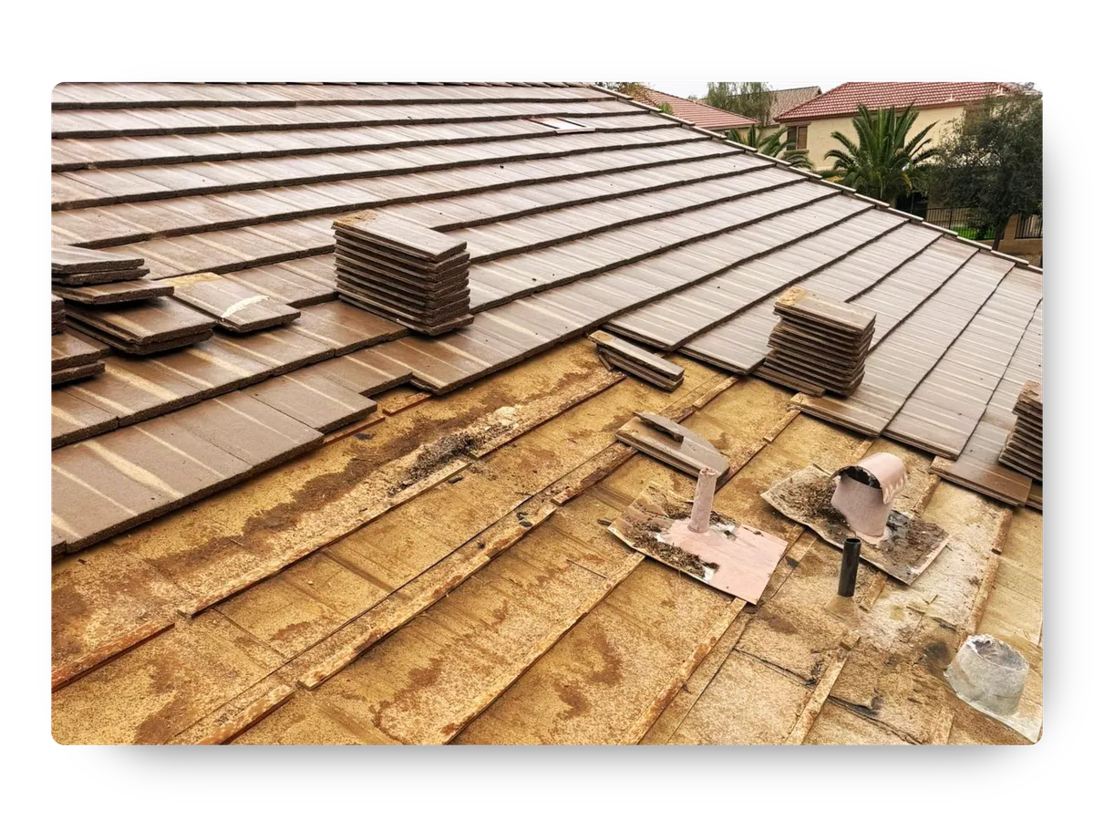Underlayment exposure during a roof replacement queen creek Arizona project with stacked tiles