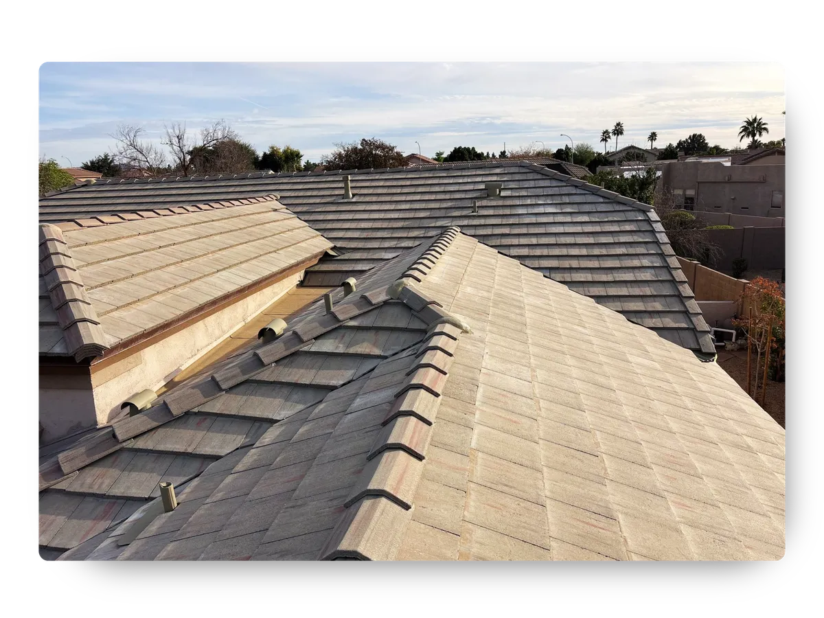 Aerial view of a multi-gabled concrete tile roof following a residential roof replacement in Gilbert.